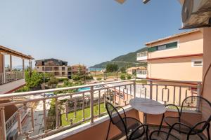 a balcony with a table and chairs and a view at Kalias Hotel in Vasiliki