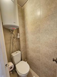 a small bathroom with a toilet and a sink at Apartment on Constantin Negruzzi in Chişinău