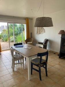 a kitchen with a table and chairs and a dining room at Maison 400m de la plage in Crozon +9 photos
