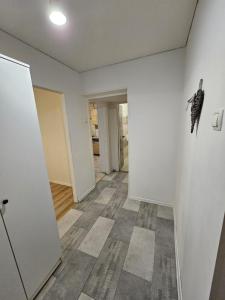 an empty room with white walls and a floor at Apartment on Constantin Negruzzi in Chişinău