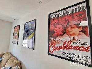 a wall with three framed movie posters on it at 4 bedroom 'Screen6' by Tunnels Beaches in a historic building in Ilfracombe