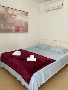 a bedroom with a bed with two towels on it at Apartmani Mirta in Dramalj