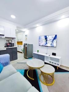 a living room with a couch and a table at Heartland Gardens Apartments Kilimani Nairobi in Nairobi