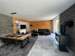 a living room with a wood stove and a couch at Chalet Filipsky Deluxe in Ždiar