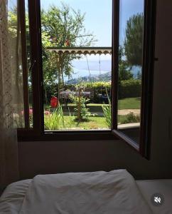 a bedroom with a window looking out at a garden at Zeytinlik Suits in Akcaabat