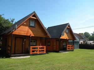 a large wooden house with a black roof at Anna i Halina in Sztutowo