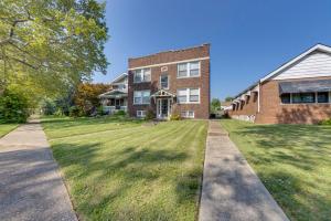 a large brick building with a grass yard at Inviting St Louis Apartment - Great Location! in Lemay
