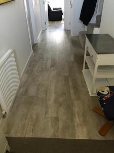 a hallway with a wooden floor in a house at large en suite bedroom for 1-4 persons No breakfast provided in Edinburgh