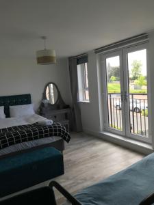 a bedroom with two beds and a balcony at large en suite bedroom with one double bed No breakfast provided in Edinburgh