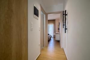 a hallway leading to a room with a bedroom at Yellow Lux Central Suite in Alexandroupoli