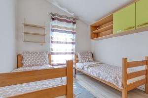 a bedroom with two bunk beds and a window at Mara in Umag