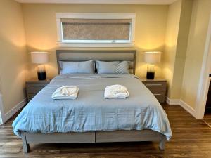 a bedroom with a bed with two towels on it at Lotus Moon in Charlottetown