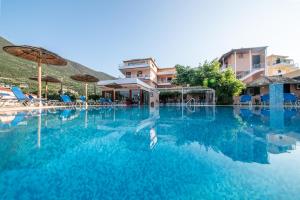 a swimming pool at a resort with blue water at Kalias Hotel in Vasiliki