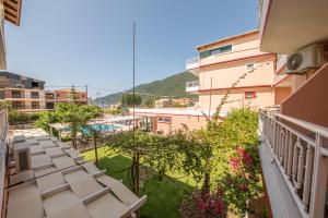 a balcony with a view of a pool and buildings at Kalias Hotel in Vasiliki