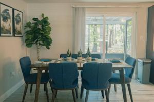 a dining room with a table and blue chairs at The Lake House (Tampa / LUTZ area) in Lutz