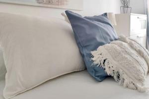 a bed with two pillows and a blanket on it at La Casa de los Tiles in Vélez Blanco