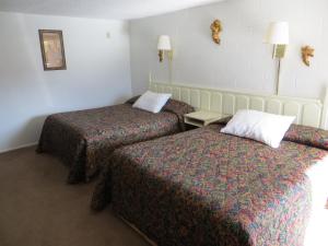 a hotel room with two beds in a room at Holiday Lodge in Hawthorne