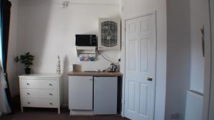 um quarto com uma cozinha com um balcão e uma porta em Vernon Lodge Flat 2 em Bournemouth