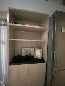 a cupboard with a shelf with a box on it at Seaside pearl in Lygia