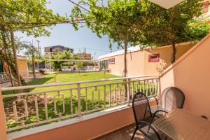 a balcony with chairs and a view of a park at Kalias Hotel in Vasiliki