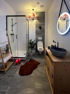 a bathroom with a sink and a glass shower at "Hunter's Suite"- at the heart of Hartberg I Parking in Hartberg