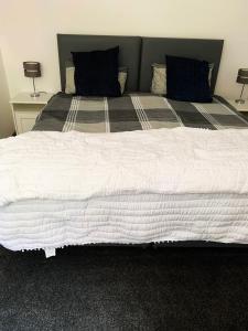 a large white bed with two pillows on it at Erehwon - History in Bodmin in Bodmin