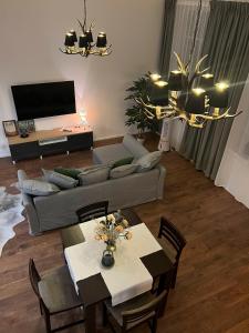 a living room with a couch and a table at "Hunter's Suite"- at the heart of Hartberg I Parking in Hartberg
