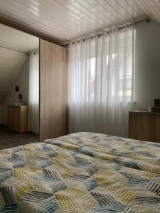 a bedroom with a bed and a large window at Seeglück22 in Reichenau
