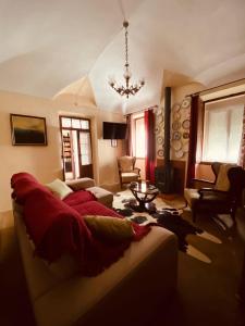 a living room with a couch and a chandelier at Casa DAlva in Vila Alva