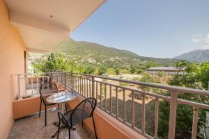 a balcony with two chairs and a table at Kalias Hotel in Vasiliki