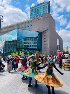 a group of people in costumes in front of a building at Station 173 D Bruxelles-charleroi-airport in Charleroi