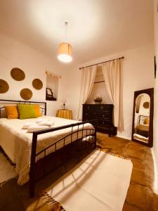 a bedroom with a bed and a dresser and a mirror at Casa DAlva in Vila Alva