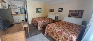 Postel nebo postele na pokoji v ubytování Windsor Motel + 21 fotografií