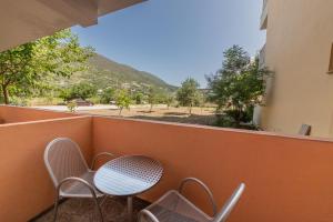 a table and chairs on a balcony with a view at Kalias Hotel in Vasiliki