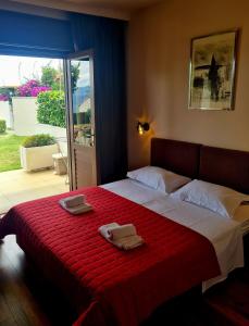 a bedroom with a bed with two towels on it at Beach Villa Bozikovic in Podstrana
