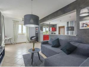 a living room with a couch and a table at Villa Tomko in Brovinje