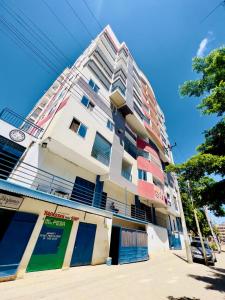 a tall apartment building on a city street at Medzam Homes Spacious Newly Furnished Studio in Mombasa