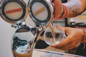 a person is pouring wine into a glass at The Galley Party Hostel in Shkodër