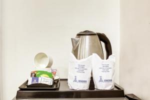 a tea kettle and a toaster on a table at Gracious by Vishesh Hotels & Home Stay in New Delhi