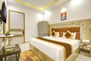 Ліжко або ліжка в номері Gracious by Vishesh Hotels & Home Stay