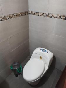 a bathroom with a white toilet in a room at Chimborazo Basecamp in Chimborazo