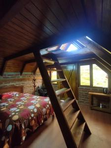 a room with a bed and stairs in a cabin at Chimborazo Basecamp in Chimborazo