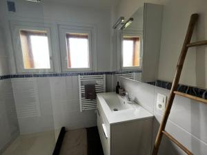 a white bathroom with a sink and a mirror at Appartement dans chalet - 75 m2 - 4 à 6 personnes in Saint-Gervais-les-Bains +31 photos
