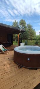 a large hot tub sitting on a wooden deck at Stacja Roztocze in Majdan Kasztelański