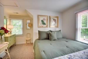a bedroom with a bed and a desk and windows at Mobjack Bay Rental on Private Cove! in Onemo