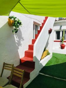 a staircase leading up to a house with a green tent at Casa DAlva in Vila Alva