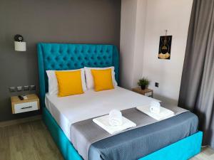 a bedroom with a blue bed with two towels on it at Katerina's Resort in Sarti