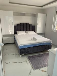 a bedroom with a bed in a white room at Draga in Ulcinj