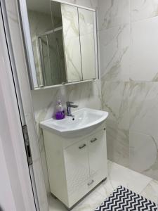 a white bathroom with a sink and a mirror at Draga in Ulcinj +7 photos