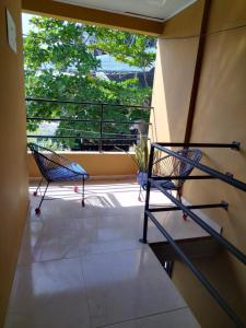 two chairs on a balcony with a view of trees at Apartamento la esmeralda! in Puerto Triunfo